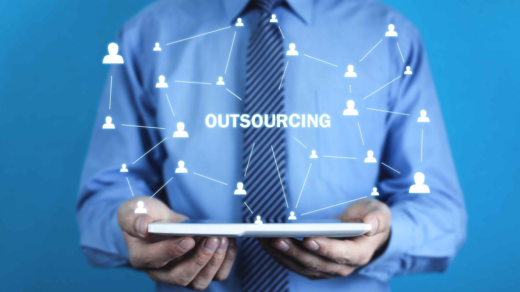 Profissional segurando um tablet com ilustrações de conexões humanas e a palavra "Outsourcing".